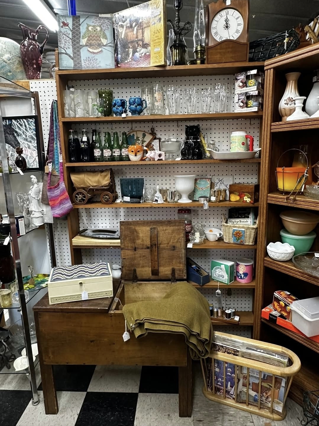 Freshly stocked vintage shelving with glassware and home goods