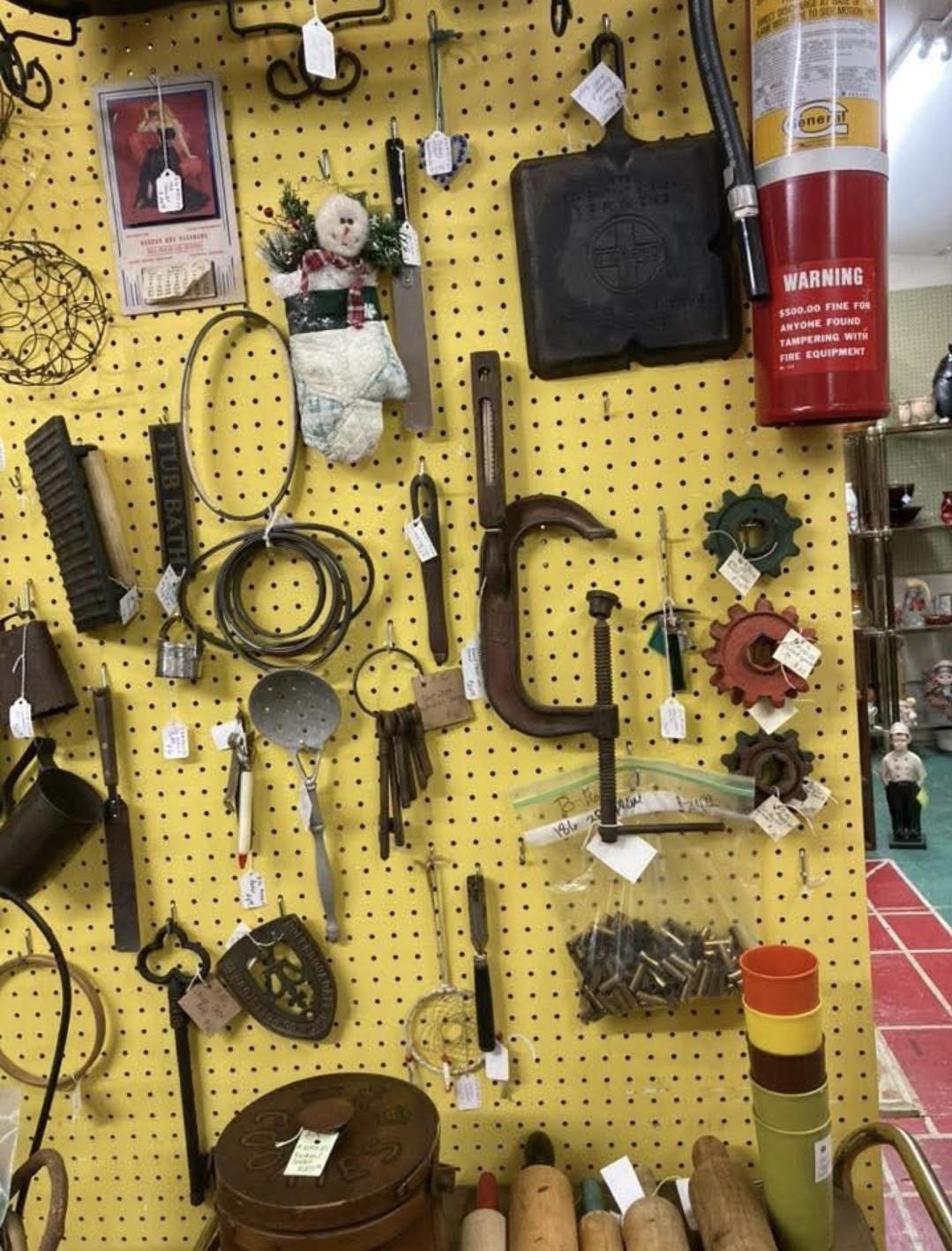 Vintage tools and hardware on pegboard display